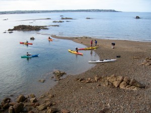 sea kayaks on the beach by Seymour tower jersey